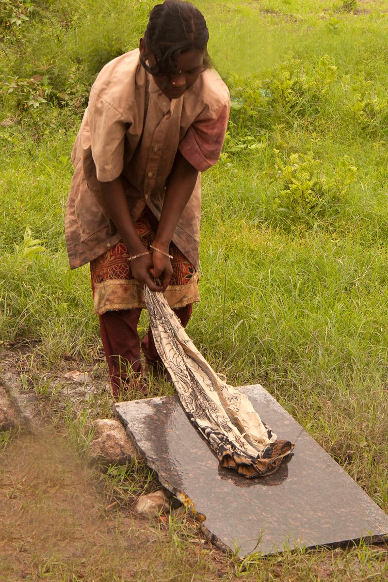The cloth is beaten on a stone slab to remove impurities. col-sm-4